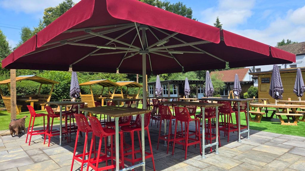 The garden — spacious, with covered pods and an outdoor bar